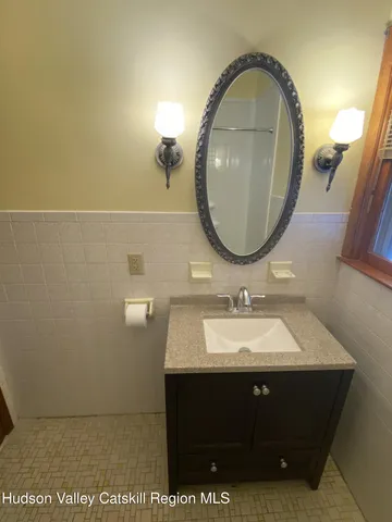 a room with a bed window and dresser