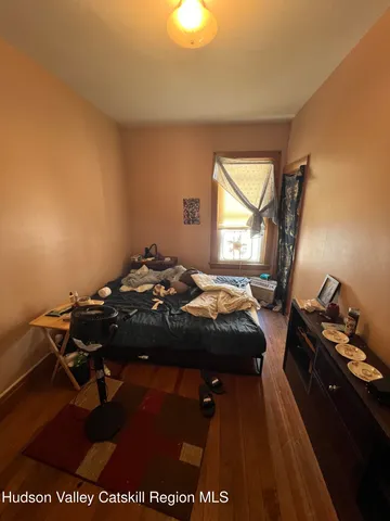 a bedroom with furniture and a window