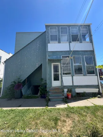 a view of a backyard with table and chairs under an umbrella