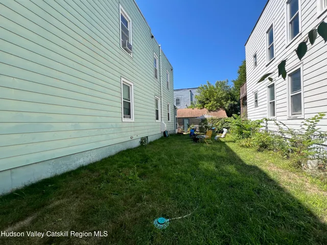 a view of a back yard of the house and front view of a house