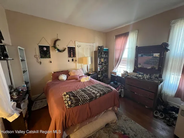 a living room with furniture fireplace and a large window