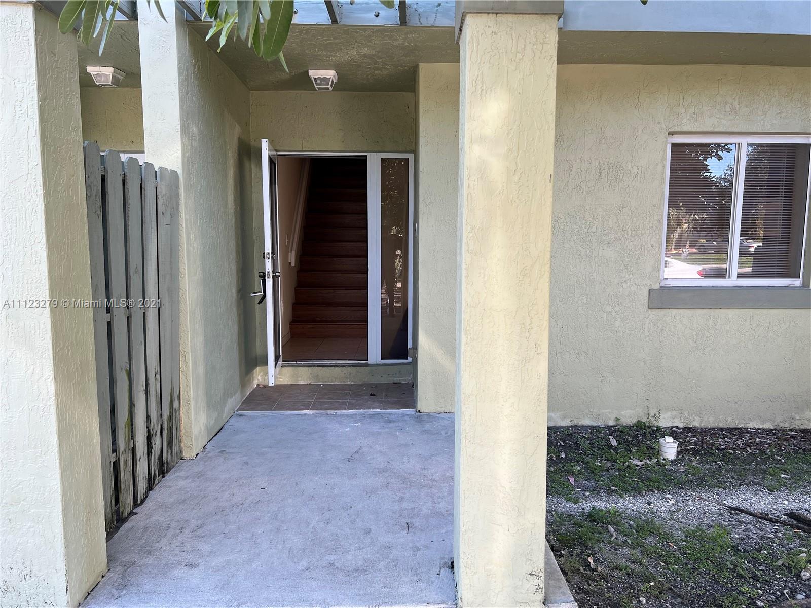 a view of a hallway with a door and wooden door