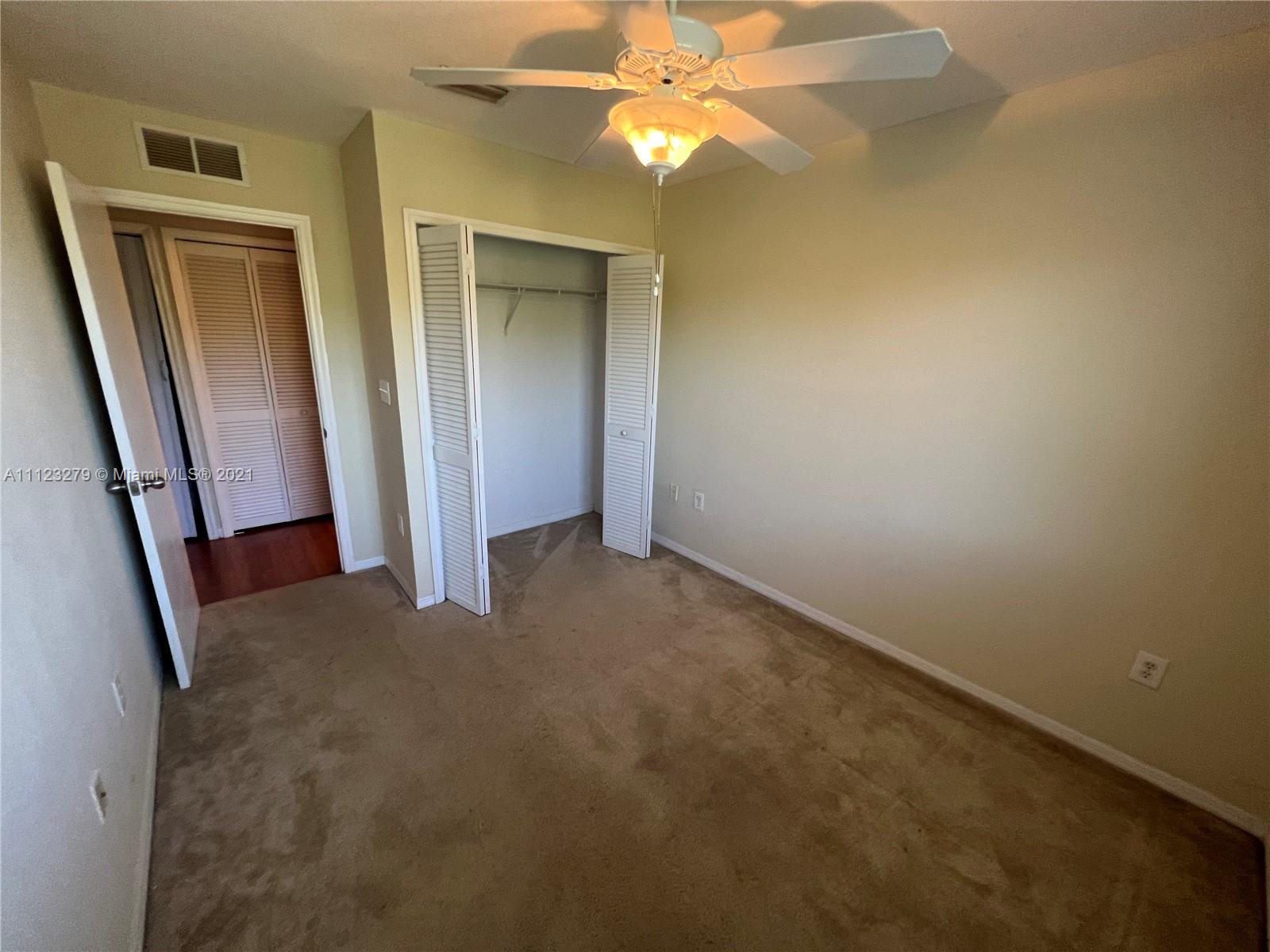 20441 Northwest 15th Avenue, Unit 8 Miami Gardens, FL 33169 - Photo 17 of 30 an empty room with windows and entrance