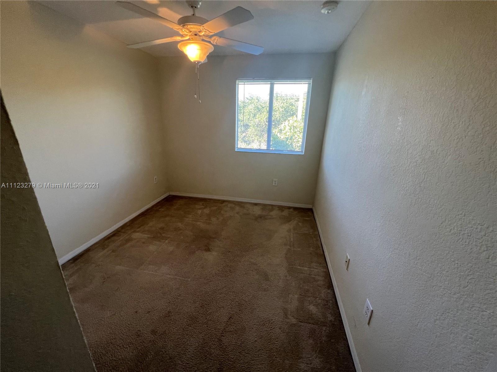 20441 Northwest 15th Avenue, Unit 8 Miami Gardens, FL 33169 - Photo 18 of 30 an empty room with windows and closet