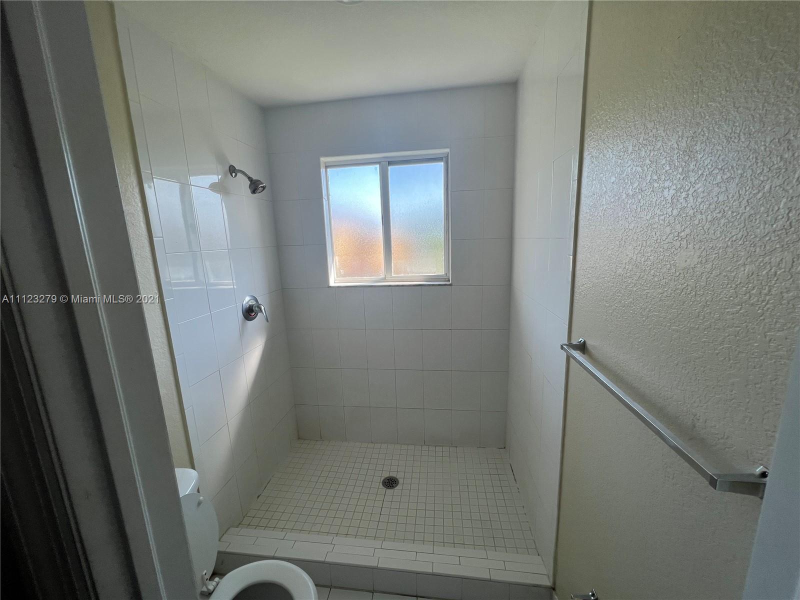 20441 Northwest 15th Avenue, Unit 8 Miami Gardens, FL 33169 - Photo 22 of 30 a bathroom with a shower and toilet