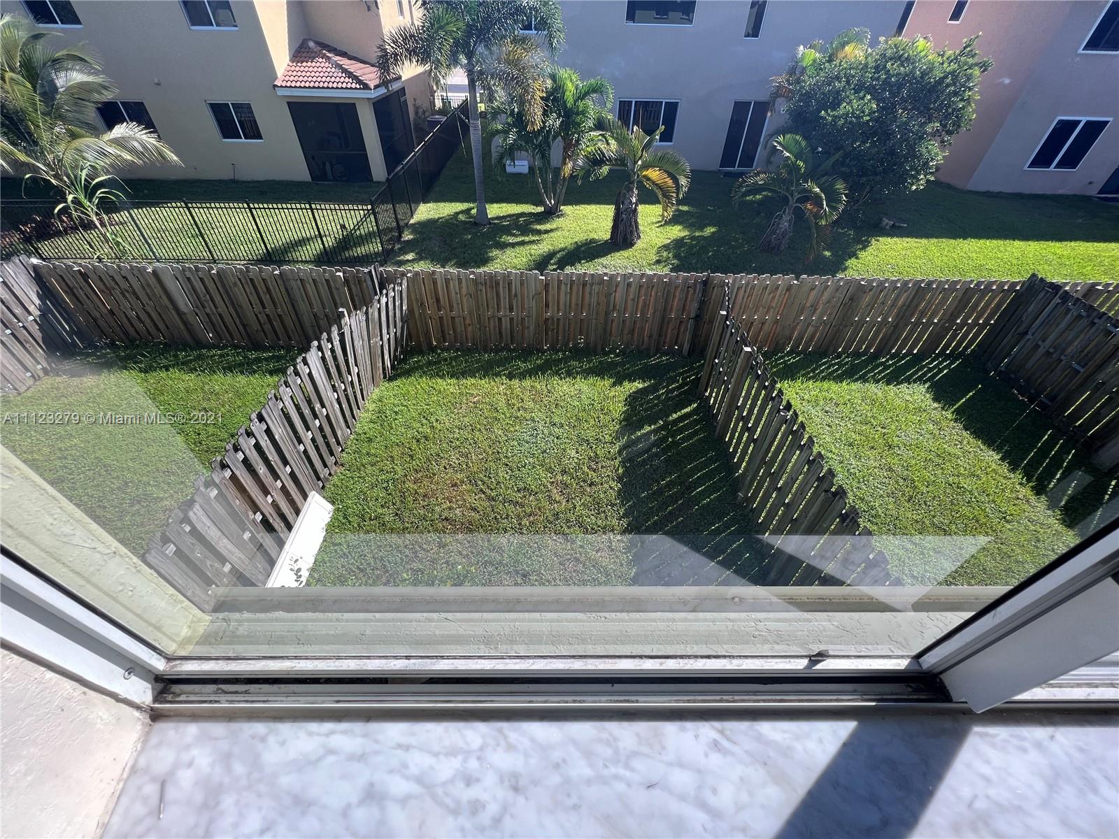 20441 Northwest 15th Avenue, Unit 8 Miami Gardens, FL 33169 - Photo 25 of 30 a view of backyard with deck and outdoor seating