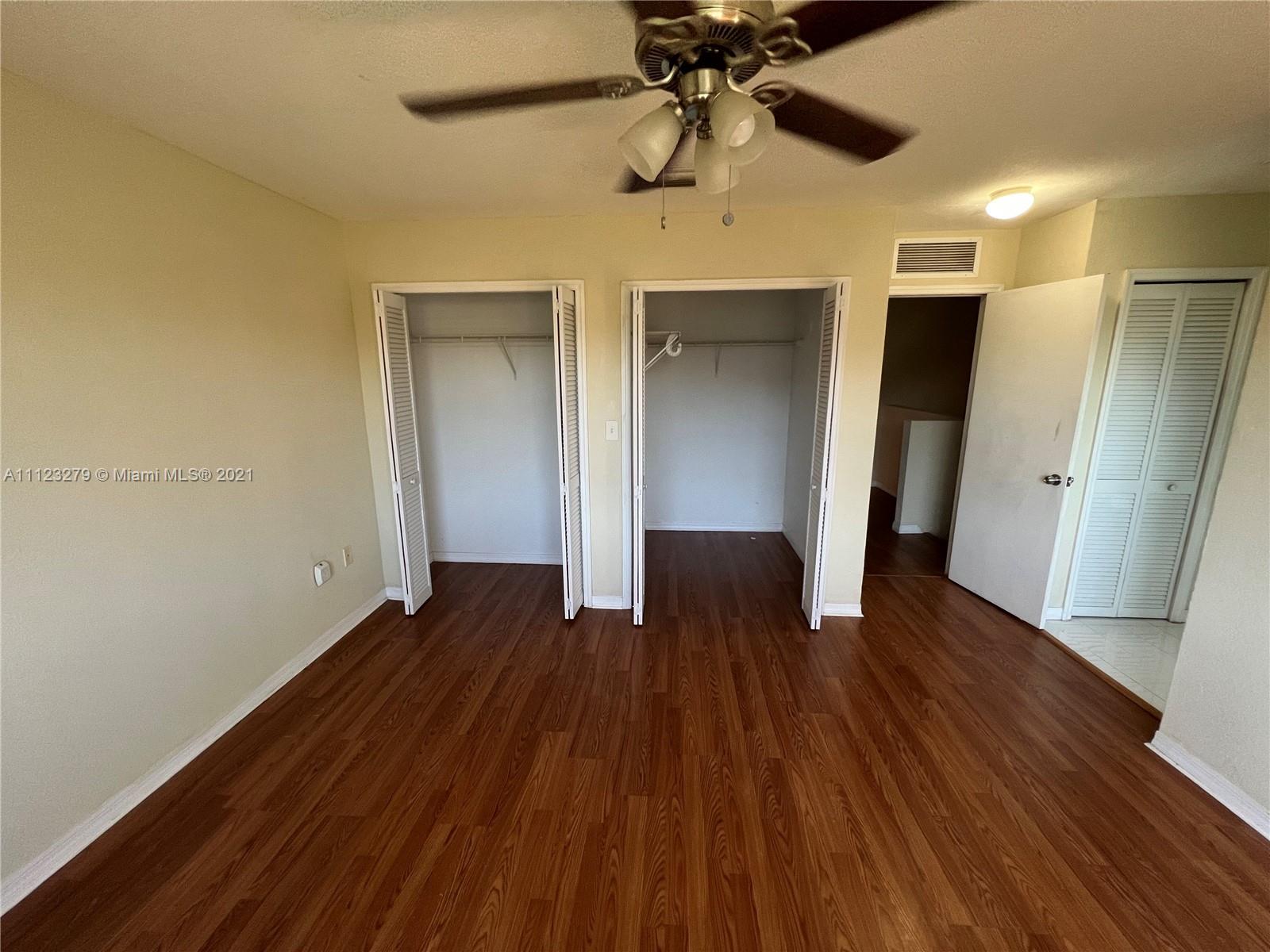 20441 Northwest 15th Avenue, Unit 8 Miami Gardens, FL 33169 - Photo 26 of 30 wooden floor in an empty room with a window