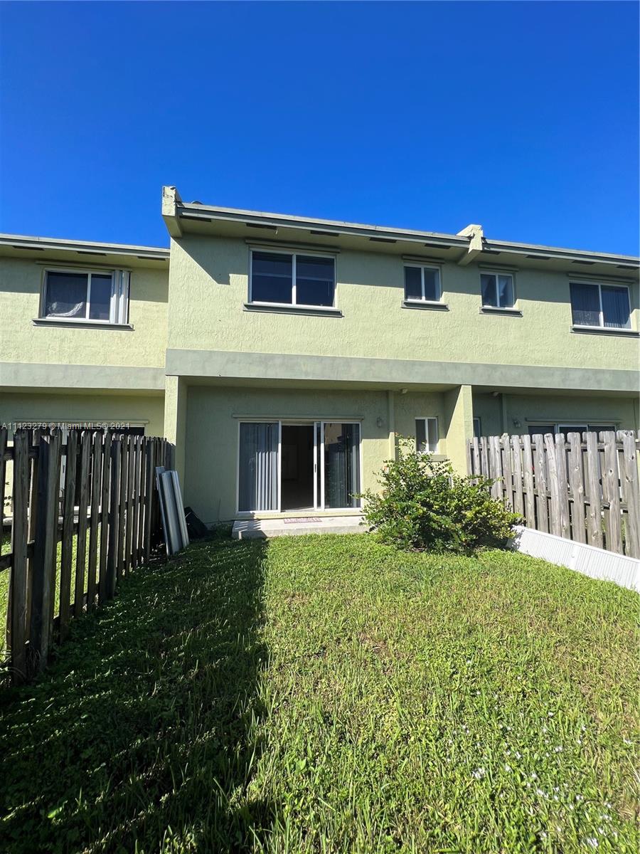 20441 Northwest 15th Avenue, Unit 8 Miami Gardens, FL 33169 - Photo 9 of 30 a front view of a house with garden