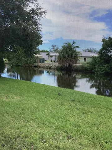 a view of a lake with houses in the back