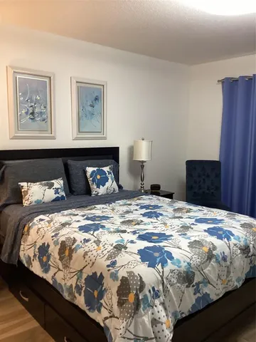 a bedroom with bed and cupboard