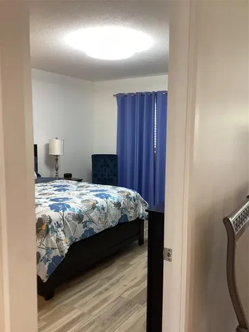 a bedroom with a bed and a mirror
