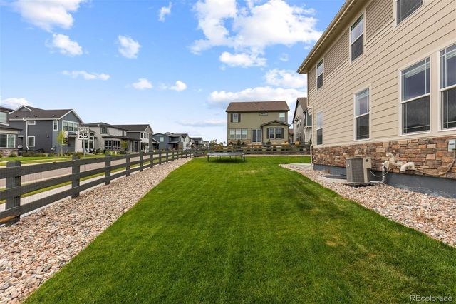a view of a house with a yard and sitting area
