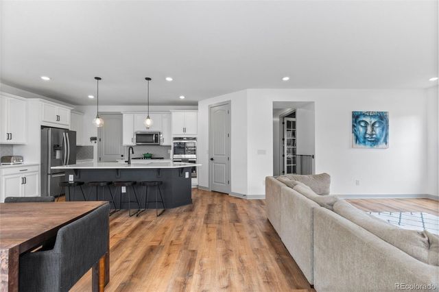a large kitchen with a center island and stainless steel appliances
