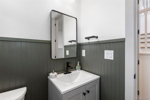 a bathroom with a sink a toilet and mirror