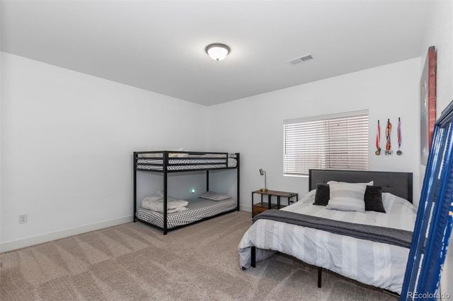 a bedroom with a bed and a night stand