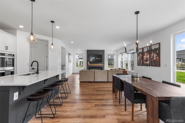 a view of kitchen with cabinets table and chairs