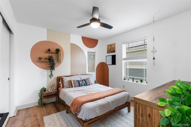 a bedroom with a large bed and a chandelier