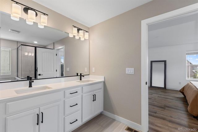 a spacious bathroom with a double vanity sink and mirror
