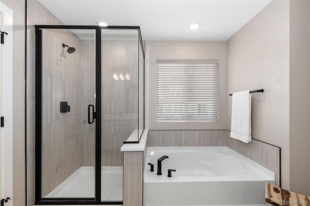 a bathroom with a bathtub and a shower