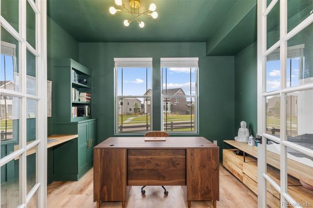 a room with pool table and windows
