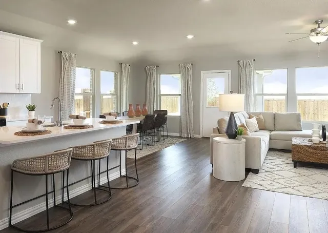 a dining room with furniture a chandelier and wooden floor