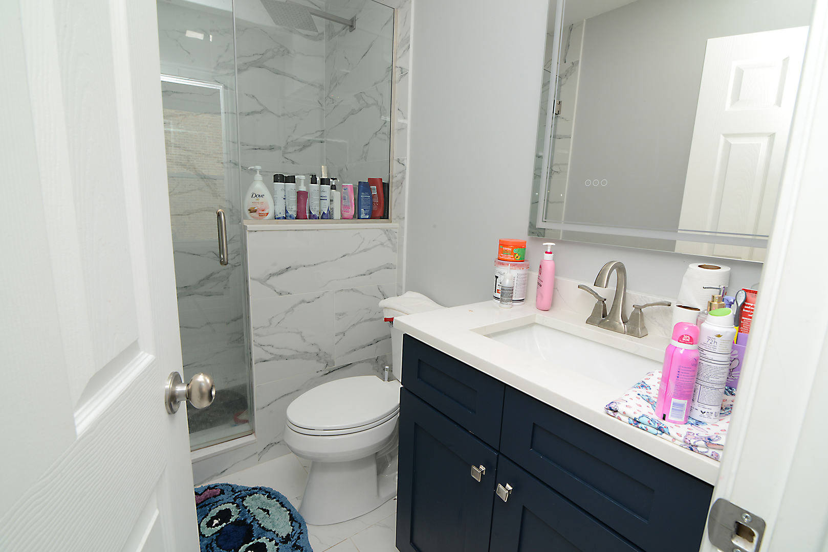 1051 North Springfield Avenue Chicago, IL 60651 - Photo 48 of 50 a bathroom with a sink vanity mirror and toilet