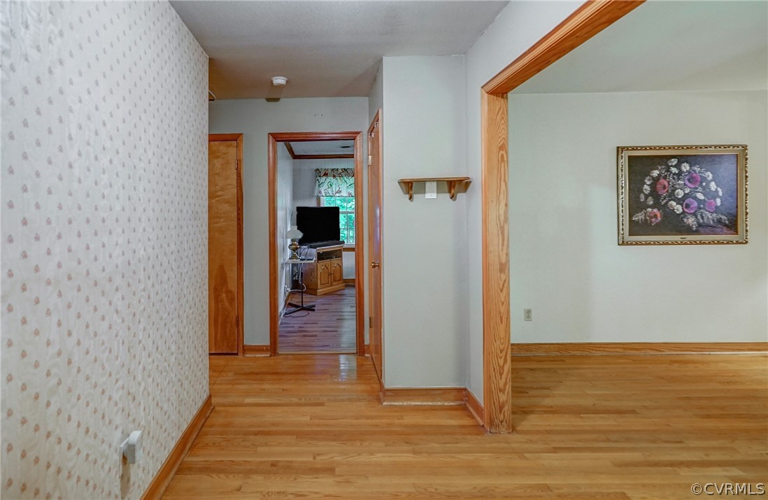 7651 Varann Road Henrico, VA 23231 - Photo 20 of 44 a view of a hallway with wooden floor and a living room