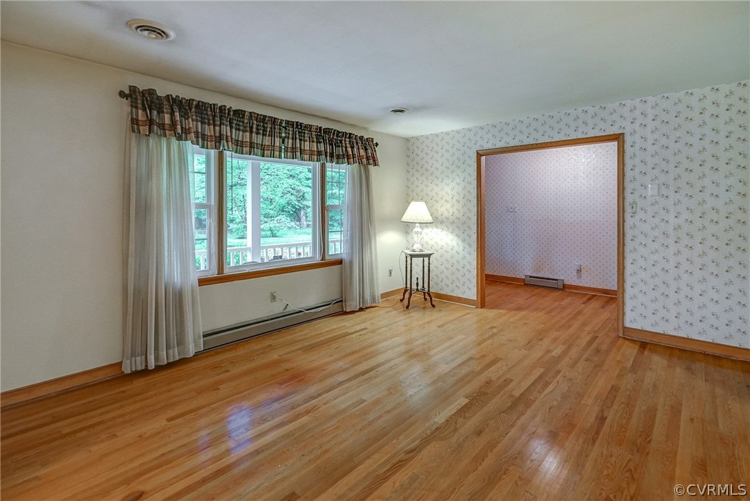 7651 Varann Road Henrico, VA 23231 - Photo 21 of 44 a view of an empty room with wooden floor and a window