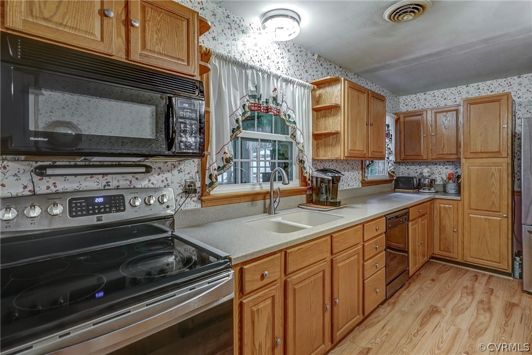 7651 Varann Road Henrico, VA 23231 - Photo 27 of 44 a kitchen with stainless steel appliances a stove sink and microwave