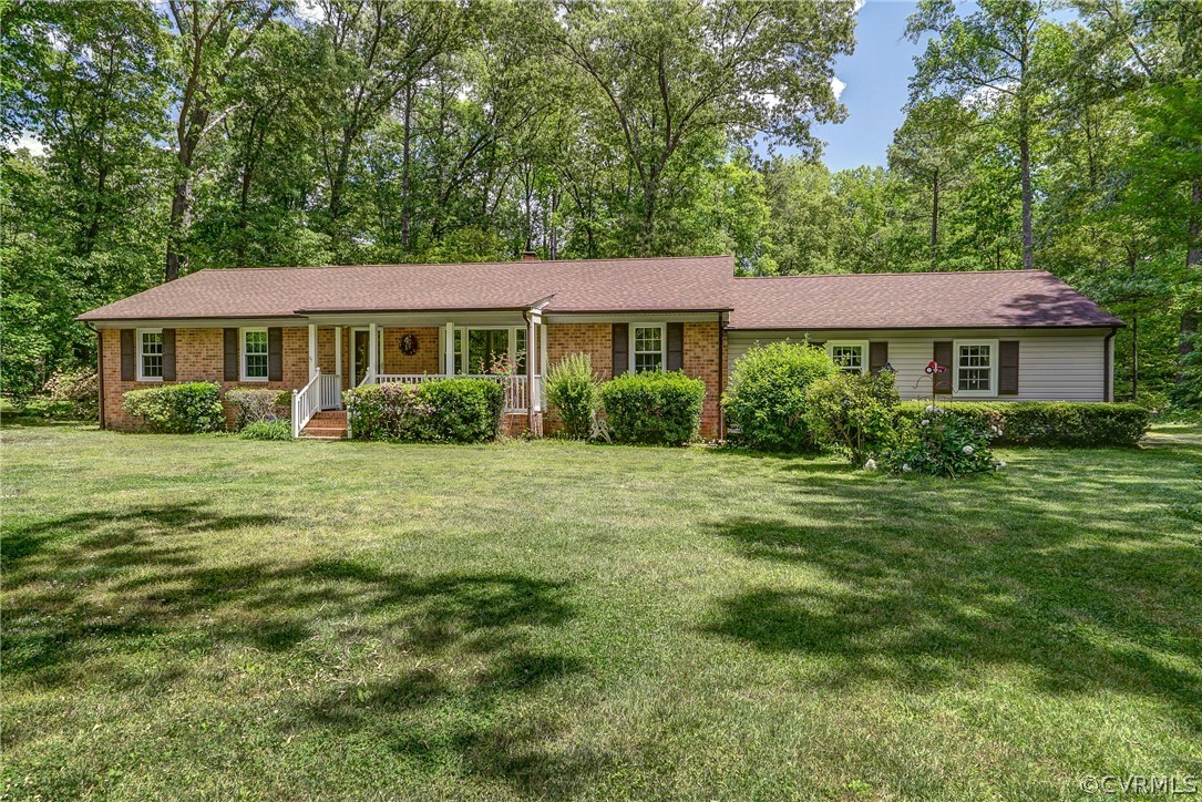 7651 Varann Road Henrico, VA 23231 - Photo 3 of 44 a front view of a house with a garden