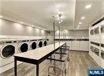 1203 River Road, Unit 19K Edgewater, NJ 07020 - Photo 16 of 19 a kitchen with stainless steel appliances kitchen island granite countertop a stove a sink and a refrigerator