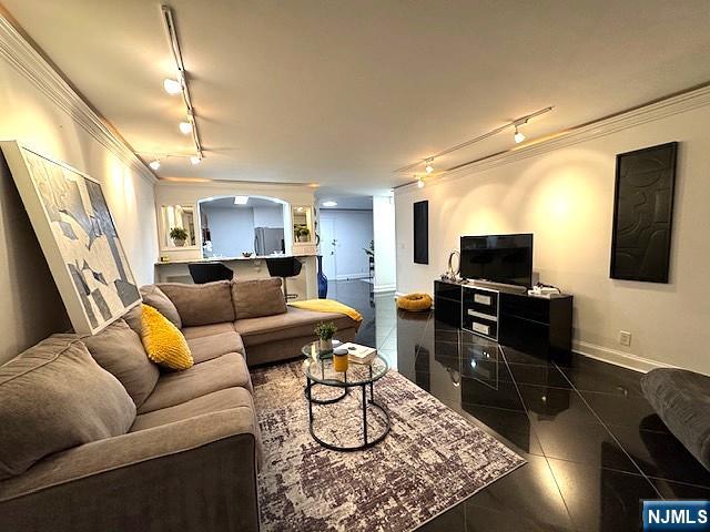 1203 River Road, Unit 19K Edgewater, NJ 07020 - Photo 4 of 19 a living room with furniture a flat screen tv and kitchen view