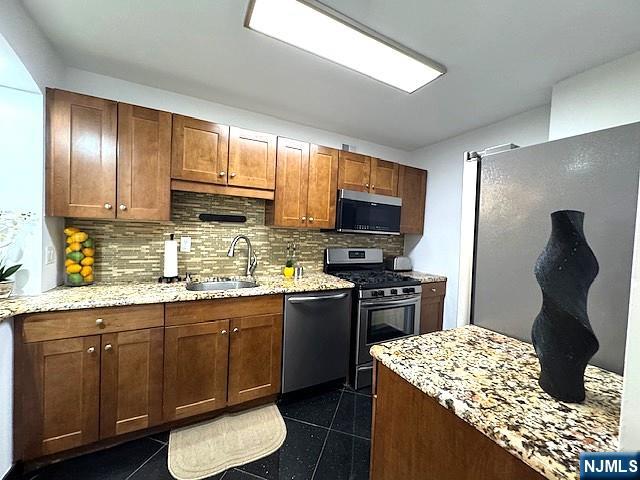 1203 River Road, Unit 19K Edgewater, NJ 07020 - Photo 6 of 19 a kitchen with a sink stove and refrigerator