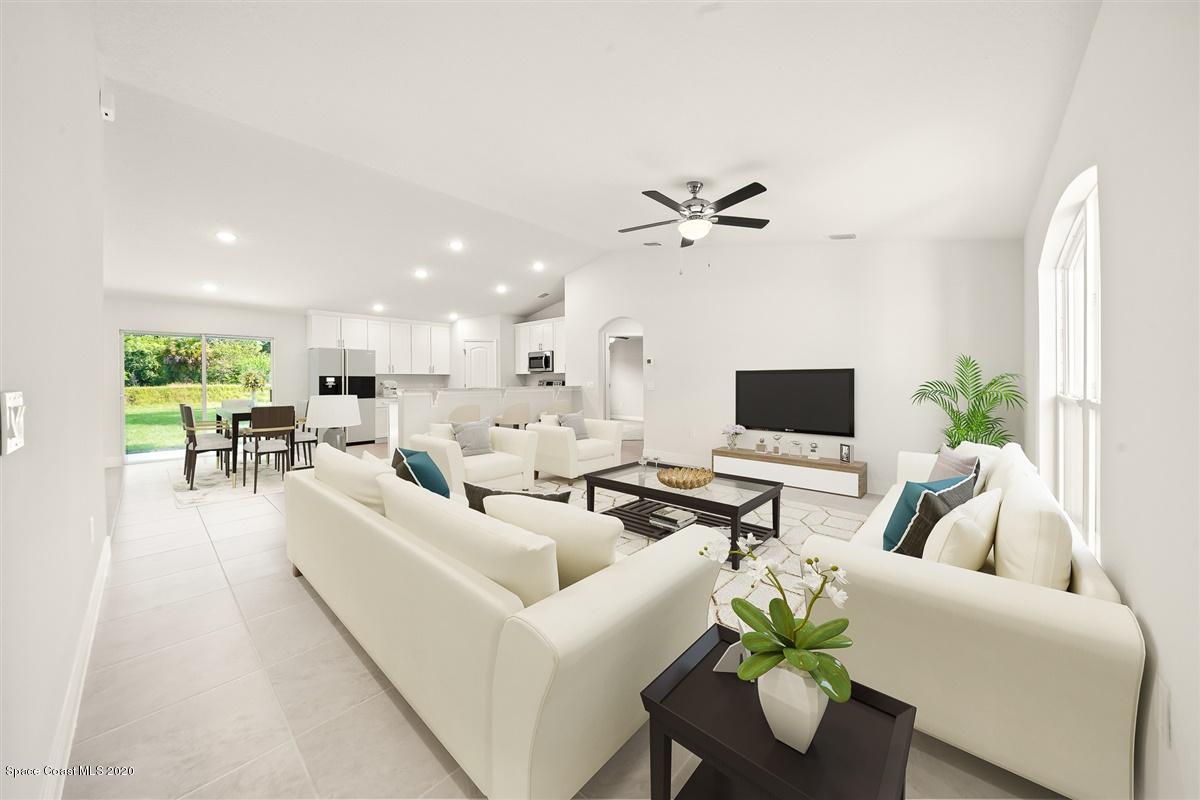 1336 Rabbit Street Southeast Palm Bay, FL 32909 - Photo 2 of 16 a living room with furniture kitchen view and a potted plant