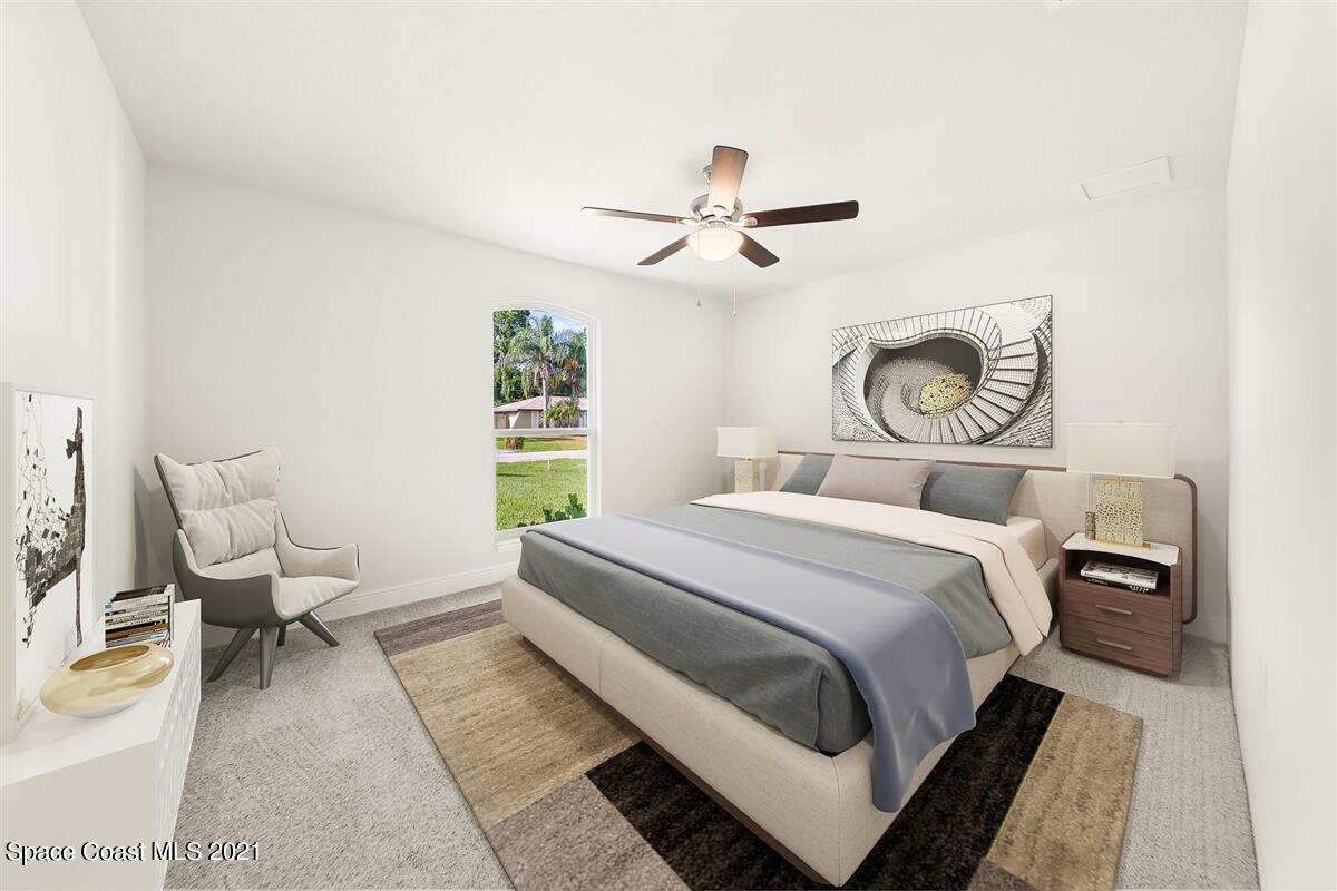1336 Rabbit Street Southeast Palm Bay, FL 32909 - Photo 4 of 16 a bedroom with a bed and wooden floor