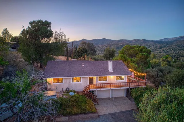 an aerial view of a house with a big yard