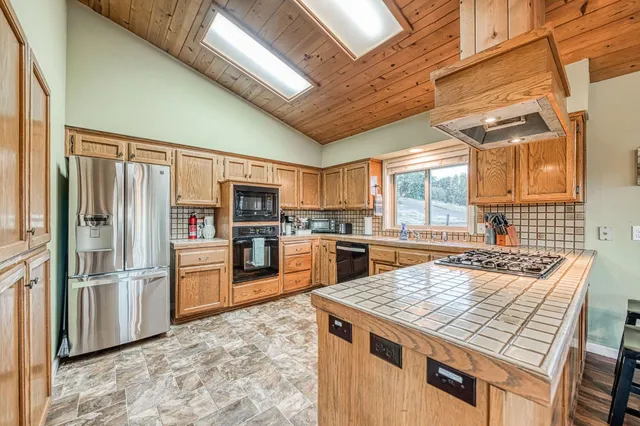 a view of a lush green field with mountains in the background