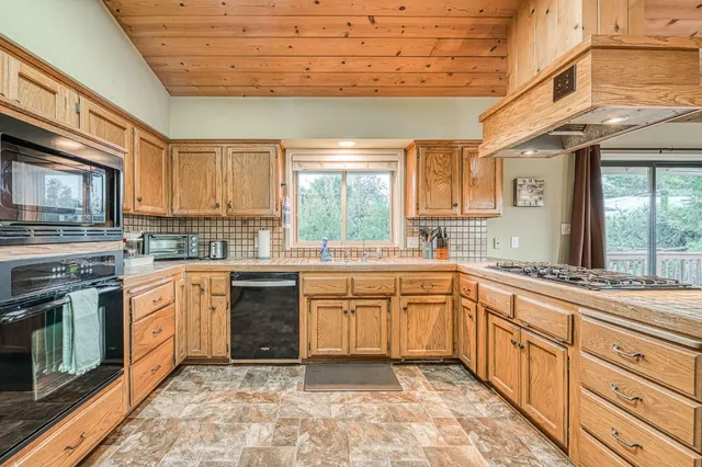 a view of a lush green field with mountains in the background