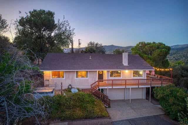 an aerial view of a house with yard and outdoor seating