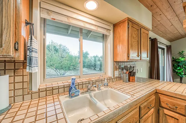 a view of a house with a tree in the yard