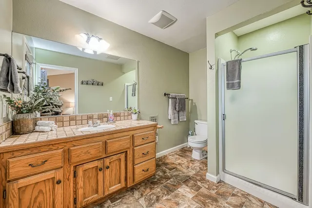 a kitchen with stainless steel appliances granite countertop a table chairs sink and cabinets
