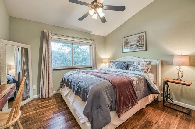 a bedroom with a large bed and a chandelier