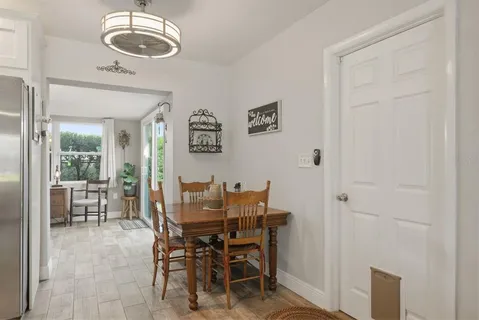 a dining room with furniture and a chandelier