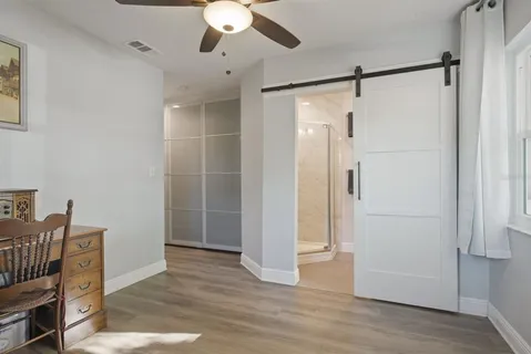 a view of empty room with wooden floor
