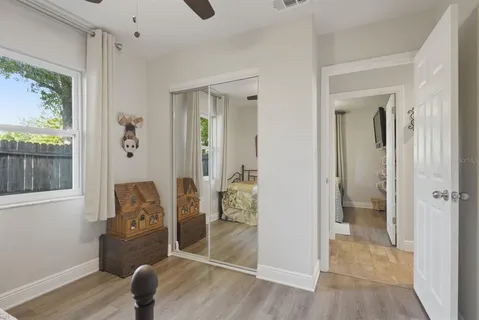 a bathroom with a granite countertop sink a toilet a mirror and shower