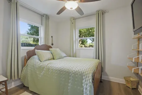 a bedroom with a large bed and a large window