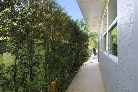 a view of backyard with a table and chair with wooden fence