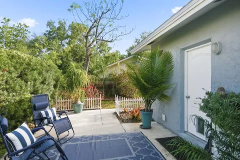 a view of a patio with a table and chairs