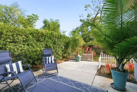 a view of backyard with outdoor seating and plants
