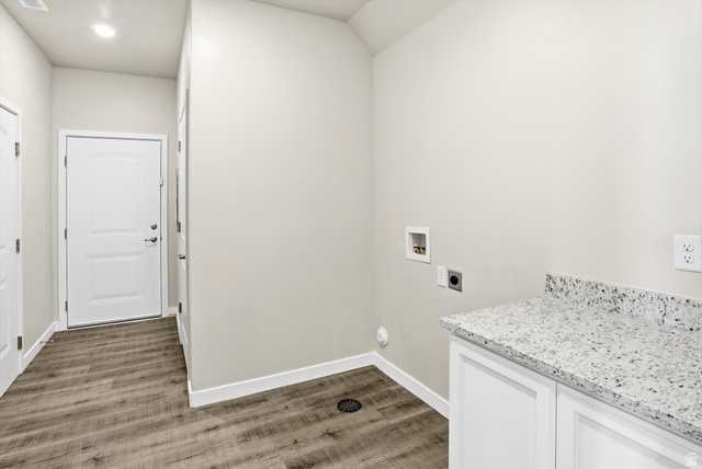 1838 West 300th Street South, Unit B Mapleton, UT 84664 - Photo 28 of 51 Laundry area featuring a speckled countertop, white cabinetry, and wood-finish flooring